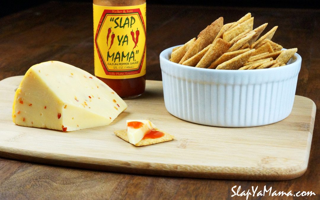 Slap Ya Mama with Cheese & crackers on a cutting board