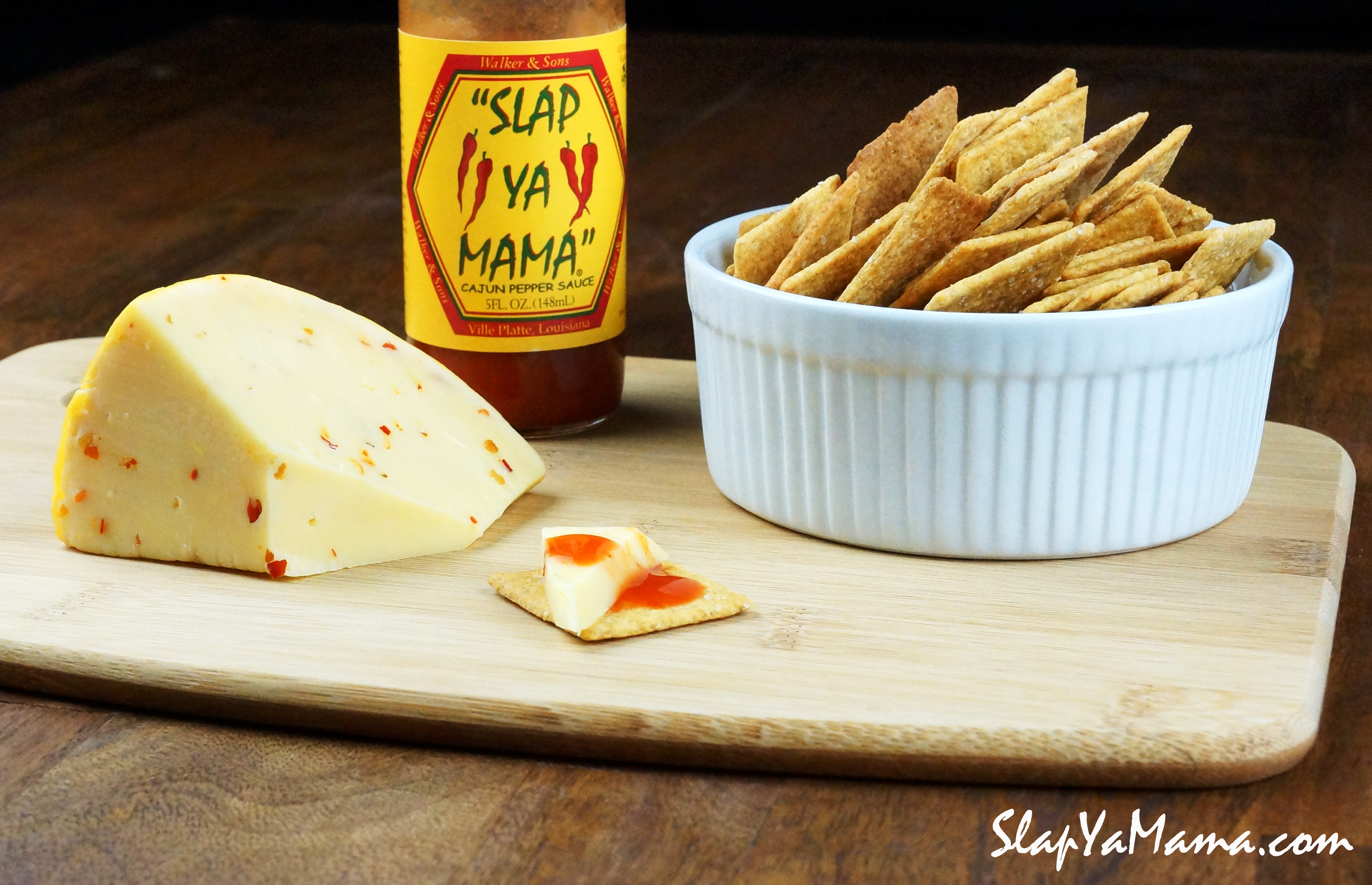 Slap Ya Mama with Cheese & crackers on a cutting board