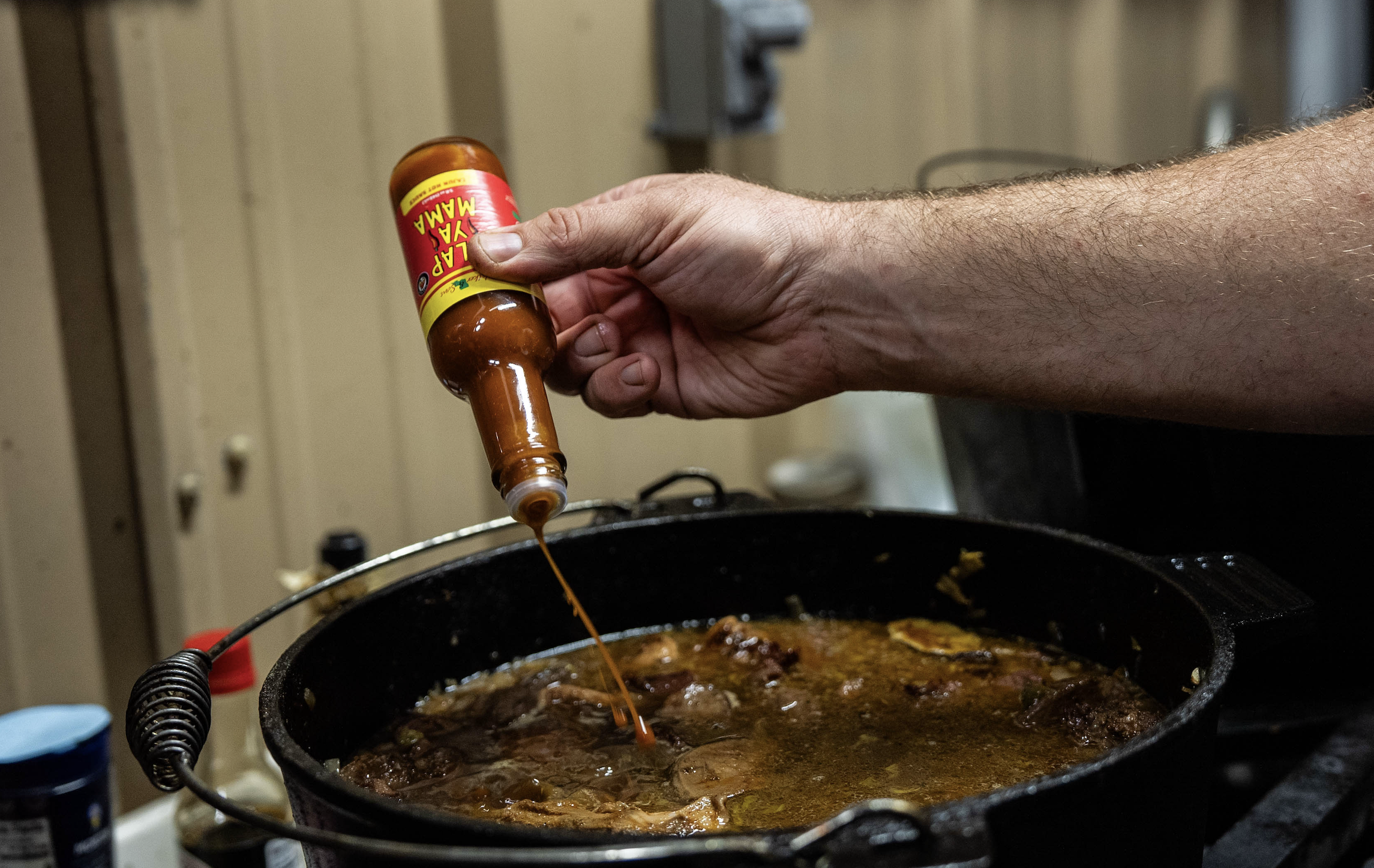 pot of sausage and rice, with slap ya mama hot sauce